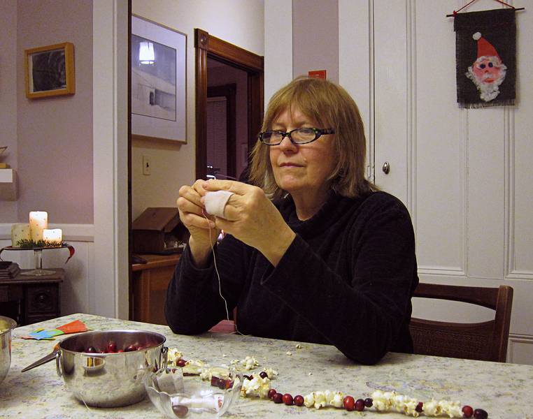 Nancy S. stringing popcorn and cranberries.<br />Christmas tree decorating party.<br />Dec. 18, 2010 - Merrimac, Massachusetts.