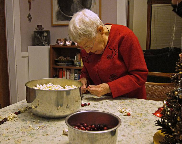 Marie stringing popcorn and cranberries.<br />Christmas tree decorating party.<br />Dec. 18, 2010 - Merrimac, Massachusetts.