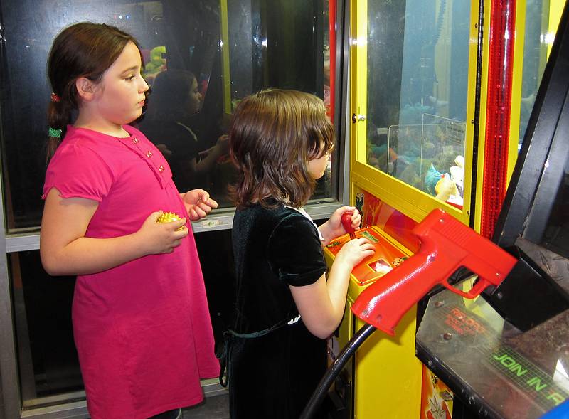 A friend and Miranda playing an arcade game.<br />Miranda's 9th birthday celebration.<br />Jan. 2, 2011 - Regal Cinemas, Bellingham, Massachusetts.