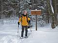 Joyce at the junction of Livermore Rd, and Kettles Path.<br />Hike from the Depot to the Scaur via Livermore, Kettles, and Scaur trails.<br />Jan. 30, 2011 - Waterville Valley, New Hampshire.