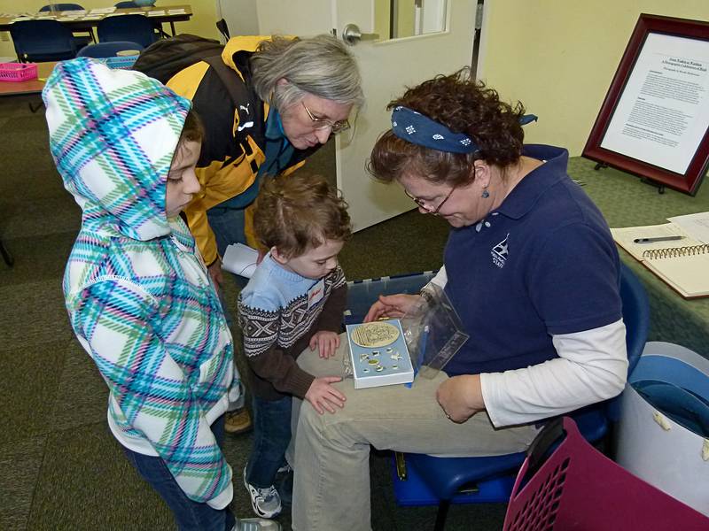 Miranda, Joyce, and Matthew looking at some scrimshaw.<br />March 5, 2011 - Mass Audubon at Joppa Flats, Newburyport, Massachusetts.