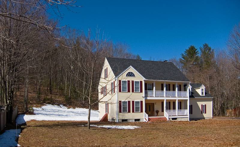 The snow still lingers in shady spots as behind this house on Winter Street.<br />April 7, 2011 - Merrimac, Massachusetts.