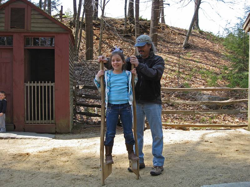 Carl helping Miranda with her stilts.<br />April 18, 2011 - Old Sturbridge Village, Sturbridge, Massachusetts.