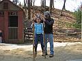 Carl helping Miranda with her stilts.<br />April 18, 2011 - Old Sturbridge Village, Sturbridge, Massachusetts.