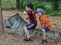 Marks and Matthew riding a white tiger (even though it's only of paper).<br />June 18, 2011 - Southwick Zoo, Mendon, Massachusetts.