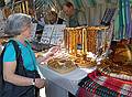 Joyce inspecting some amber necklaces.<br />Arts and crafts fair at the Latvian Ethnographic Open Air Museum.<br />June 4, 2011 - Riga, Latvia.