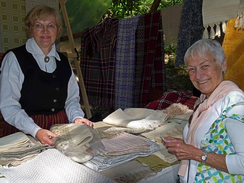 Baiba and the woman who sold her a table cloth.<br />Arts and crafts fair at the Latvian Ethnographic Open Air Museum.<br />June 4, 2011 - Riga, Latvia.