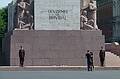 Guards (and a couple) at the base of the Freedom Monument.<br />Text reads: For Fatherland and for Freedom.<br />June 12, 2011 - Riga, Latvia.