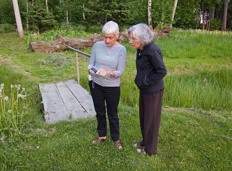 Baiba and Joyce reviewing a photo.<br />June 9, 2011 - At Annas Resort, Zaubes pagasts (parish), Latvia.
