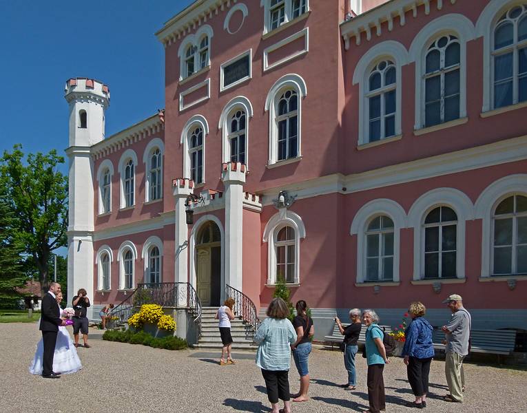 Our group with guide and a wedding couple with photographer met at the front door.<br />Birinu Palace grounds.<br />June 11, 2011 - Birini, Latvia.