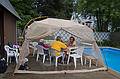 Marie, Jim, and Paul trying to stay dry.<br />July 8, 2011 - At Marie's in Lawrence, Massachusetts.