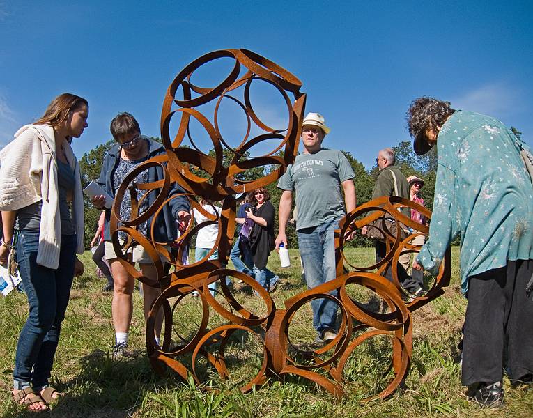 People inspecting Kevin Quinn's sculpture.<br />Artists' tour of 'Play', an Outdoor Sculpture Show at Maudslay.<br />Sept. 17, 2011 - Maudslay State Park, Newburyport, Massachusetts.