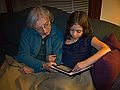 Joyce listening to Miranda reading a story on her Kindle.<br />Oct. 7, 2011 - Merrimac, Massachusetts.