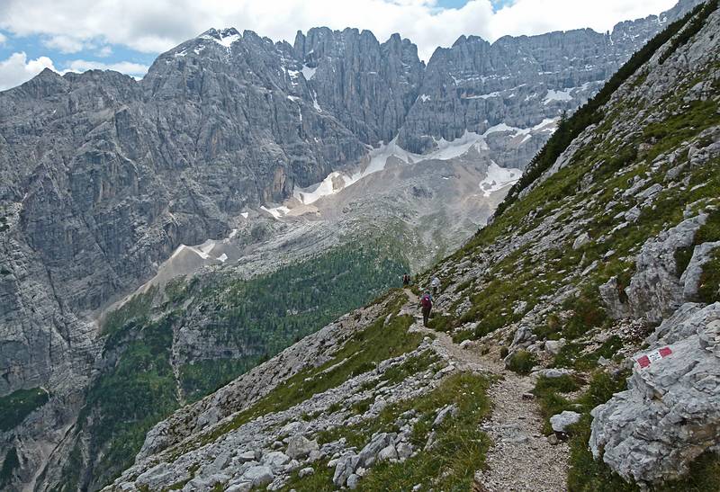 The scenery is so spectacular that Joyce is leaving me behind taking photos.<br />Hike from cable car terminal at Rifugio Faloria to Rifugio Vandelli near Lake Sorapiss.<br />July 29, 2011 - East of Cortina d' Ampezzo, Italy.