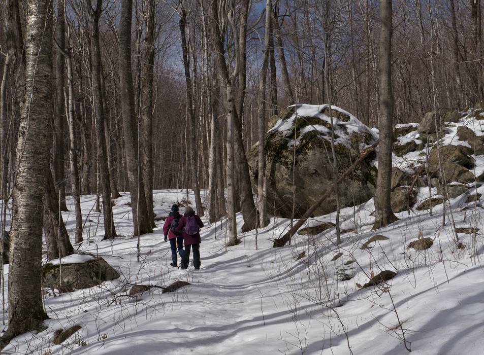 Nancy and Joyce next to an erratic.<br />Along the Brown Ash Swamp Bike Trail.<br />Feb. 19, 2012 - Waterville Valley, New Hampshire.