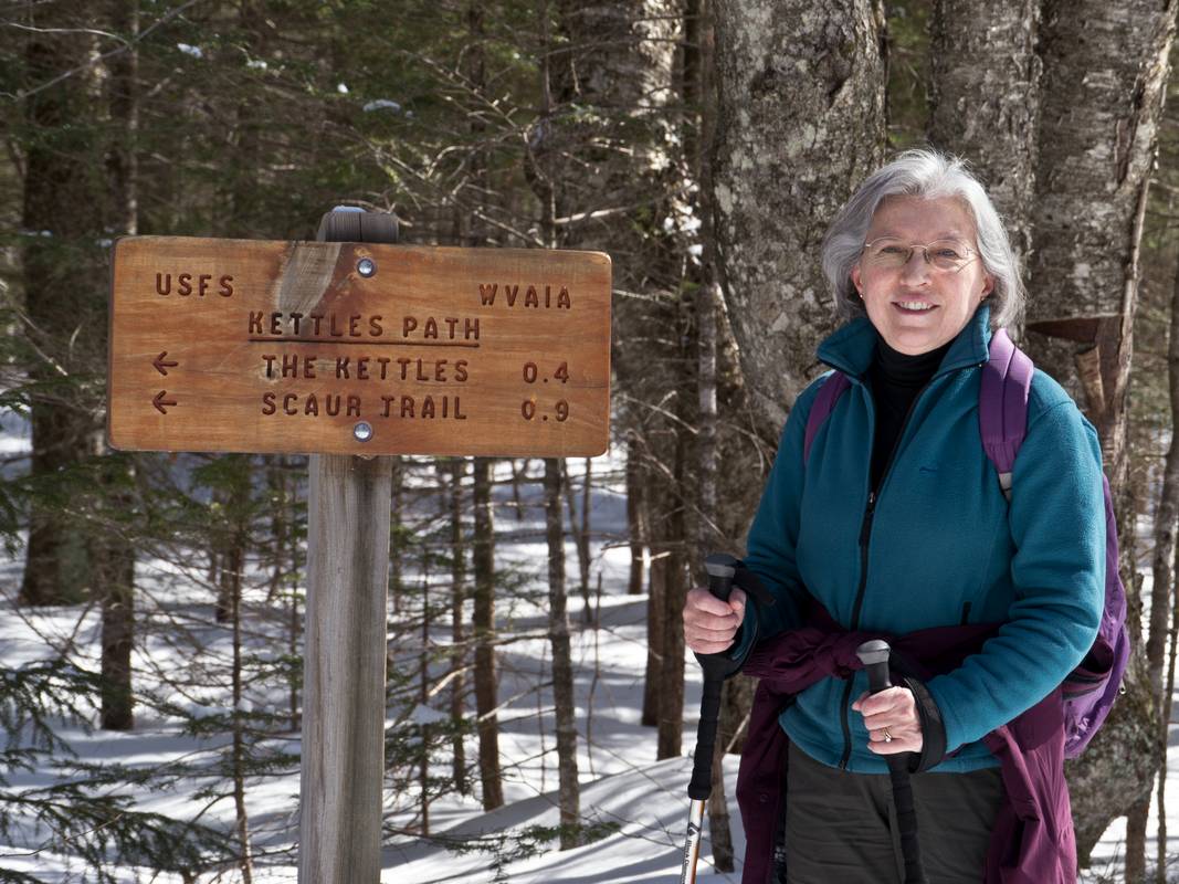 Joyce at the junction of Livermore Rd, and Kettles Path.<br />Hike from the Depot to the Scaur via Livermore, Kettles, and Scaur trails.<br />March 11, 2012 - Waterville Valley, New Hampshire.
