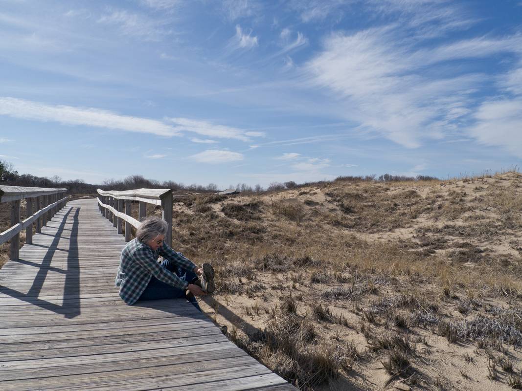 Joyce putting her shoes back on after a walk on the beach.<br />March 23, 2012 - Parker River National Wildlife Refuge, Plum Island, Massachusetts.