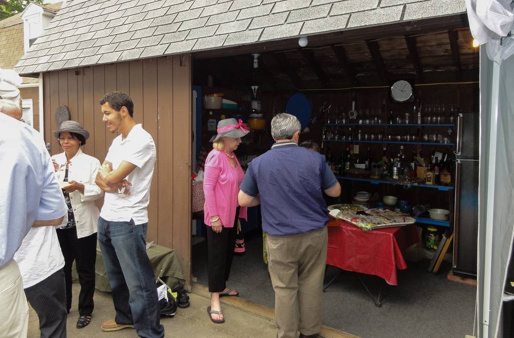 Nancy and Eriks chat while Mary and Paul.inspect the food.
