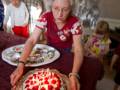 Joyce serving up a birthday cake for Carl and Egils.<br />June 9, 2012 - Merrimac, Massachusetts.