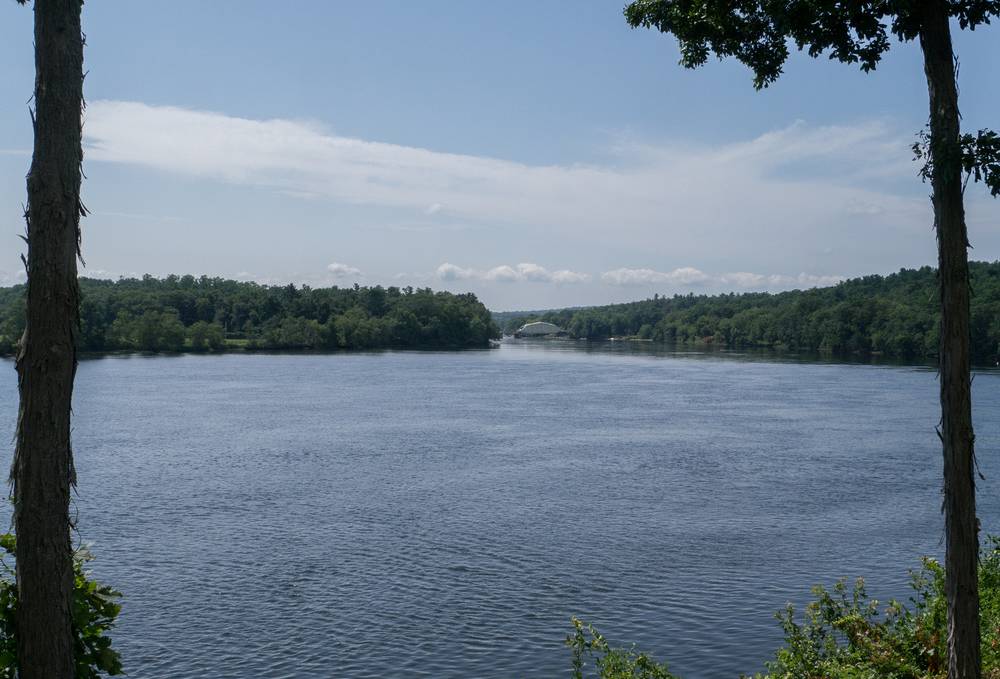 The Merrimack River and the Rocks Village Bridge under repair.<br />July 28, 2012 - Merrimac, Massachusetts.