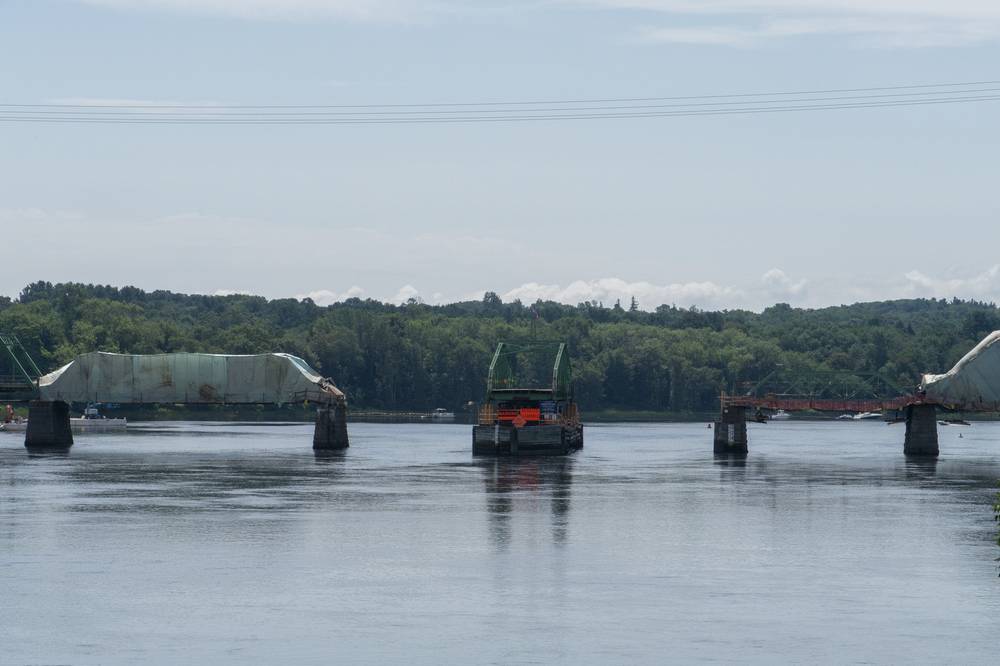 The Merrimack River and the Rocks Village Bridge under repair.<br />July 28, 2012 - Merrimac, Massachusetts.