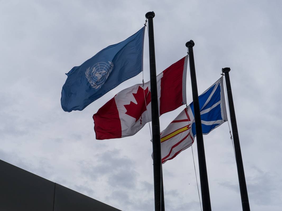 United Nations, Canada, and Newfoundland and Labrador flags<br />above the visitors center.<br />This is the first world heritage site.<br />July 8, 2012 - L'Anse Aux Meadows National Historic Site, Newfoundland, Canada.