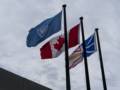 United Nations, Canada, and Newfoundland and Labrador flags<br />above the visitors center.<br />This is the first world heritage site.<br />July 8, 2012 - L'Anse Aux Meadows National Historic Site, Newfoundland, Canada.