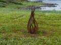 Sculpture atop a native American Indian fire pit.<br />July 9, 2012 - L'Anse aux Meadows National Historic Site, Newfoundland, Canada.