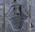 A carving in the fence.<br />July 9, 2012 - Norstead Viking Village, L'Anse aux Meadows, Newfoundland, Canada.