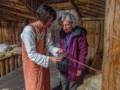 Gudrid (her character name) showing Joyce a method of weaving.<br />July 9, 2012 - Norstead Viking Village, L'Anse aux Meadows, Newfoundland, Canada.
