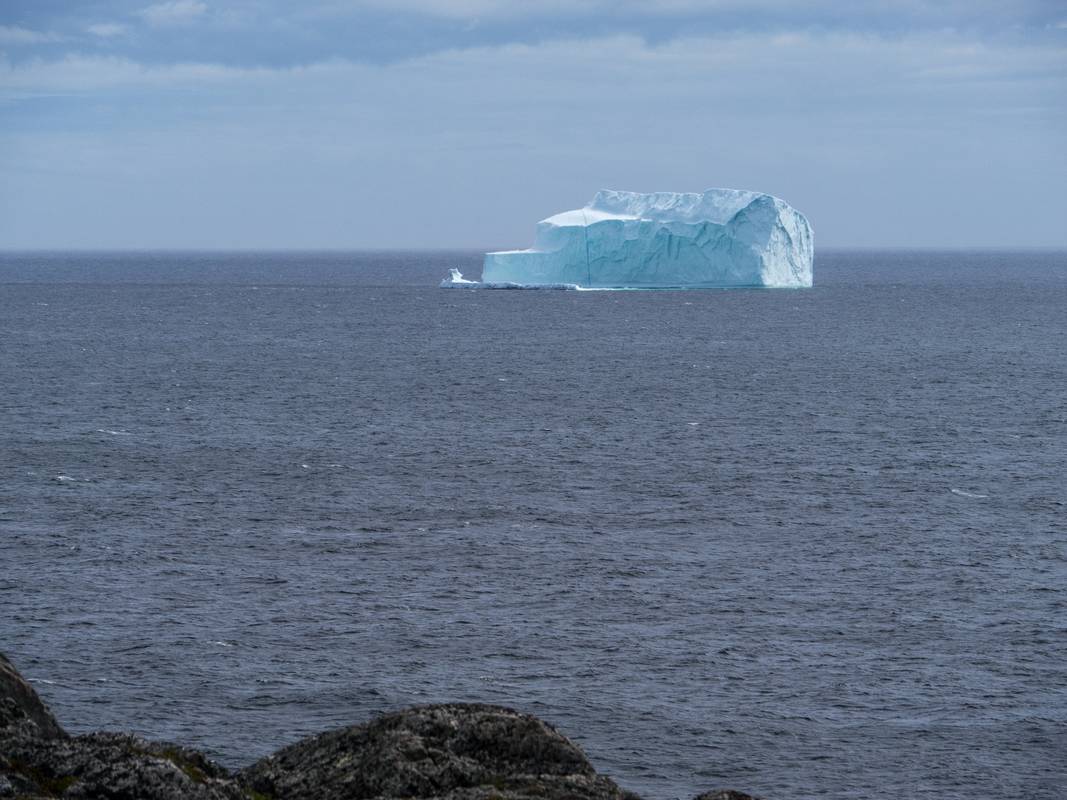 View of iceberg from ridge above the village.<br />July 10, 2012 - St. Carols, Newfoundland, Canada.