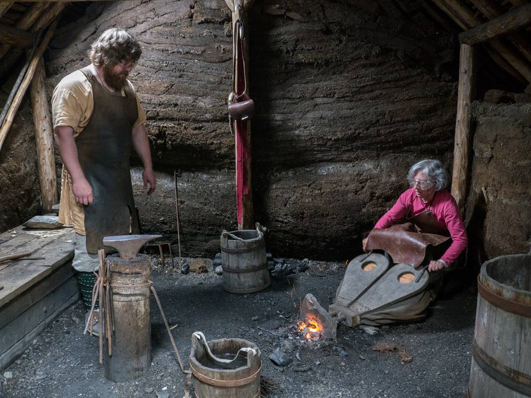Joyce apprenticing with the Norse blacksmith.<br />July 11, 2012 - L'Anse aux Meadows National Historic Site, Newfoundland, Canada.