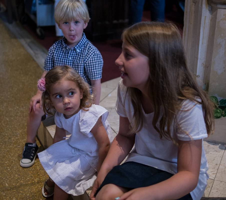 Alina admiring her cousin Marlene with William, Benjamin's brother, in back<br />Edgar's and Benjamin's Christening<br />August 5, 2012 - Queen of All Saints Church, Brooklyn, New York.