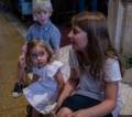 Alina admiring her cousin Marlene with William, Benjamin's brother, in back<br />Edgar's and Benjamin's Christening<br />August 5, 2012 - Queen of All Saints Church, Brooklyn, New York.