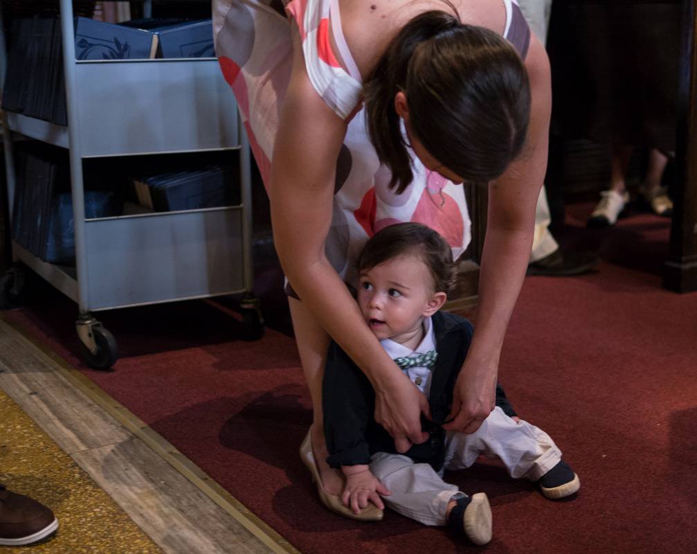 Gisela doing last minute wardrobe adjustments to Edgar.<br />Edgar's and Benjamin's Christening<br />August 5, 2012 - Queen of All Saints Church, Brooklyn, New York.