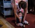Gisela doing last minute wardrobe adjustments to Edgar.<br />Edgar's and Benjamin's Christening<br />August 5, 2012 - Queen of All Saints Church, Brooklyn, New York.