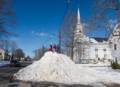 Boys playing on snow mount on Church Street.<br />Jan. 1, 2013 - Merrimac, Massachusetts.