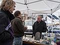 Artist Lynne and Jay talking to Michael Updake.<br />Sunday farmers' market.<br />April 14, 2013 - Newburyport, Massachusetts.