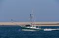 Fishing boat off Chatham Lighthouse Beach.<br />June 20, 2013 - Chatham, Massachusetts.