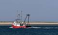 Fishing boat off Chatham Lighthouse Beach.<br />June 20, 2013 - Chatham, Massachusetts.