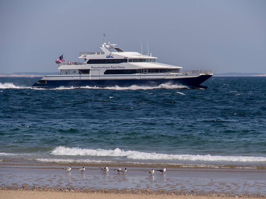 The fast ferry to Boston off Wood End beach.<br />June 21, 2013 - Provincetown, Cape Cod, Massachusetts.