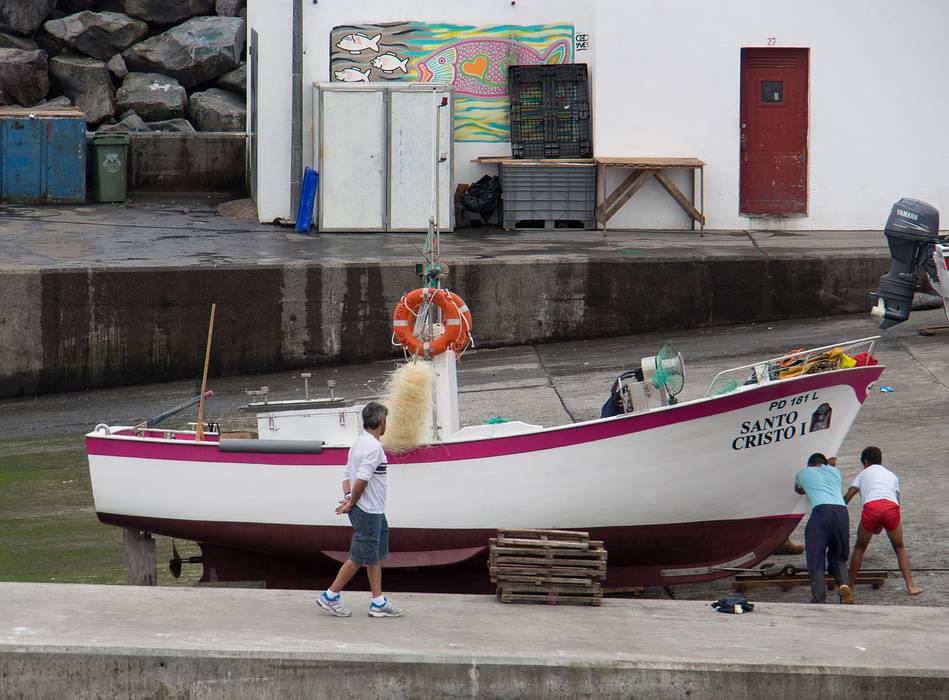 A boat being dragged away from the water and an Yves artwork in back.<br />July 12, 2013 - Lagoa, Sao Miguel, Azores, Portugal.