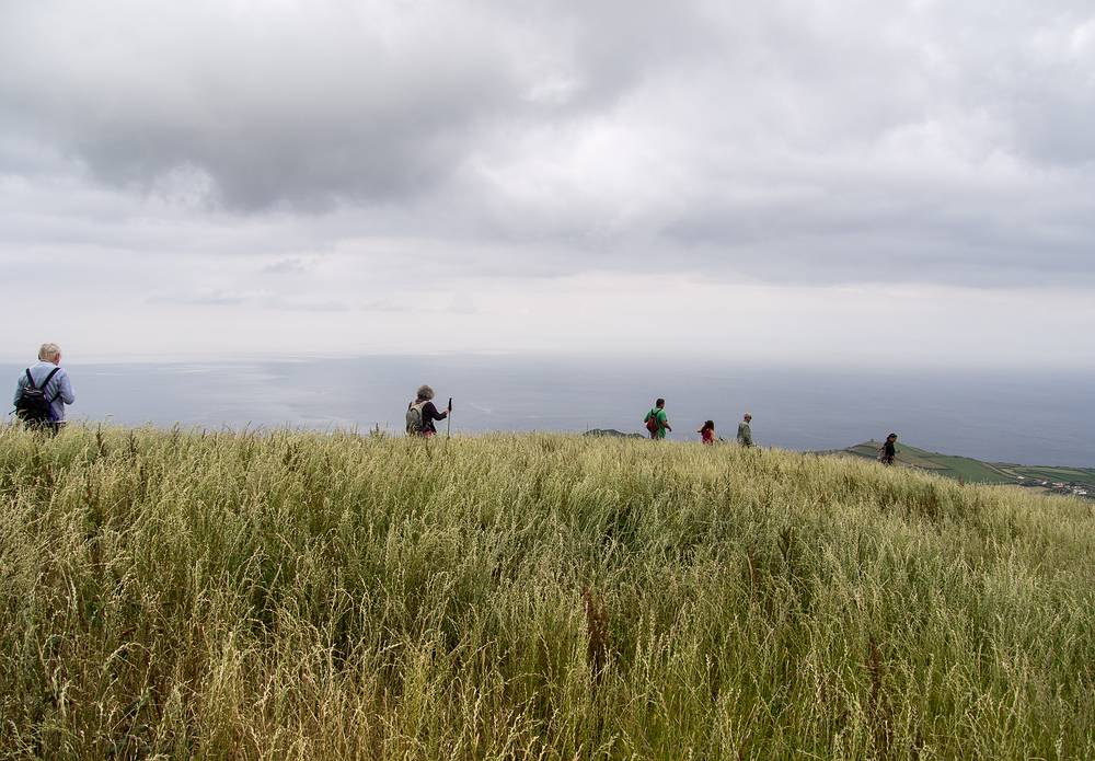 Baiba, Joyce, Sati, Miranda, Ronnie, and Melody on the lookout for the perfect lunch spot.<br />July 13, 2013 - Hike along rim of crater at Sete Cidades, Sao Miguel, Azores, Portugal.