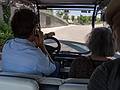 Nacho, our guide, driving golfcart with Joyce and Egils aboard.<br />July 8, 2013 - Madrid Rio Park, Madrid, Spain.
