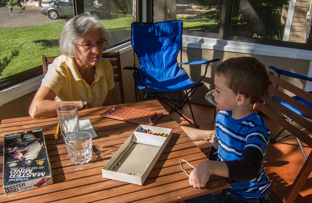 Joyce and Matthew playing Master Mind.<br />Passing the time while waiting for the Old Home Days bonfire.<br />August 10, 2013 - Merrimac, Massachusetts.