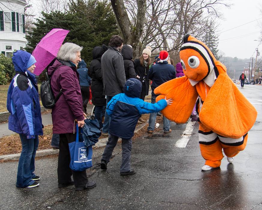 Miranda, Joyce, and Matthew high fiving Nemo.<br />Dec. 1, 2013 - Santa Parade, Merrimac, Massachusetts.