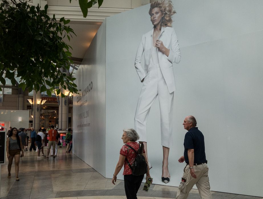 Joyce and Tom striding in the Prudential Center mall.<br />June 8, 2014 - Boston, Massachusetts.