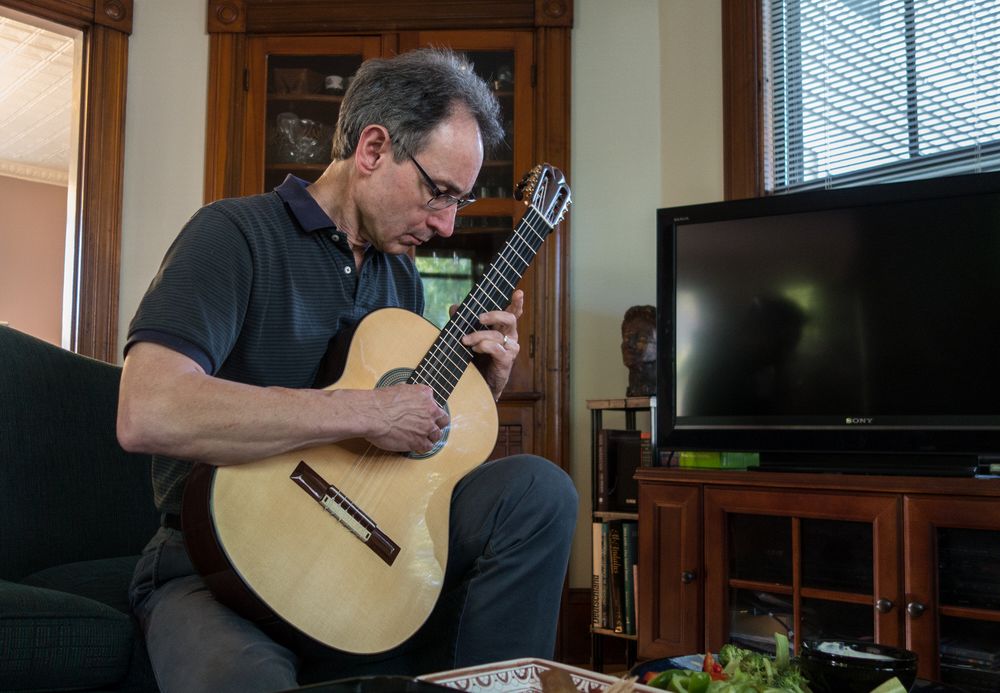 Oscar playing one of the guitars that he made.<br />June 14, 2014 - Merrimac, Massachusetts.