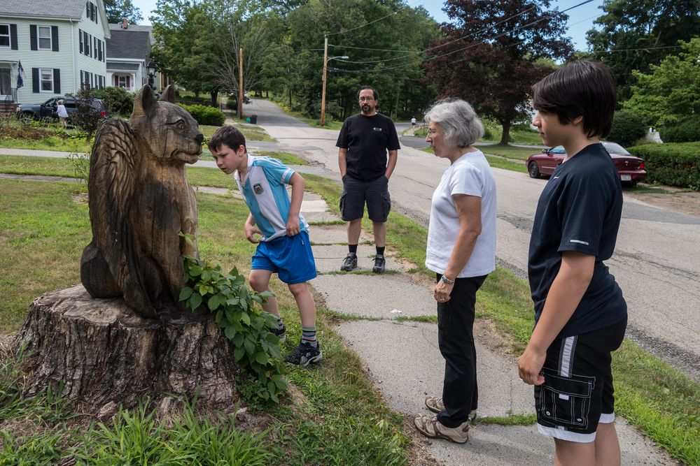 Marks, Eric, Joyce,  and Gujn inspectng the wood carving accross the street.<br />July 10, 2014 - Merrimac, Massachusetts.