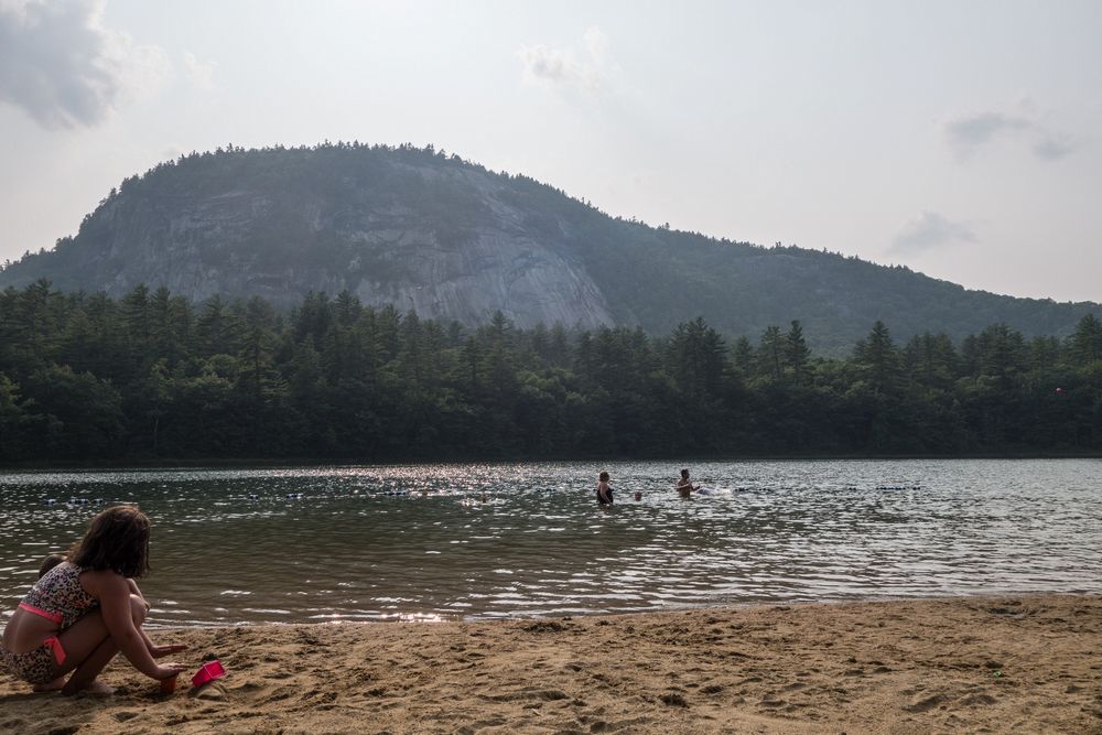 Mirand and Matthew (and two other kids) in the water.<br />White Horse Ledge is in the background.<br />July 25, 2014 - Echo Lake, Conway, New Hampshire.